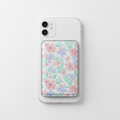 Bloom MagSafe Wallet in floral pastel design attached to iPhone on white background
